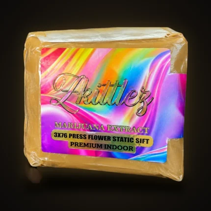 A pack of Zkittlez pressed flower static sift with a holographic rainbow label, premium indoor